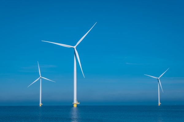 Huge windmill turbines, Offshore Windmill farm in the ocean Westermeerwind park , windmills isolated at sea on a beautiful bright day Netherlands Flevoland Noordoostpolder